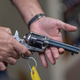 Props expert Guillaume Delouche at Independent Studio Services holds a prop gun while talking about them in Sunland-Tujunga, Los Angeles, California on October 22, 2021.